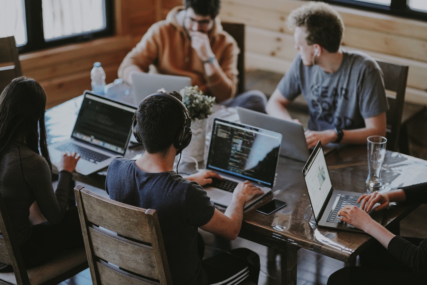 A cohort working on laptops during an AI money-ops sprint at the push desk