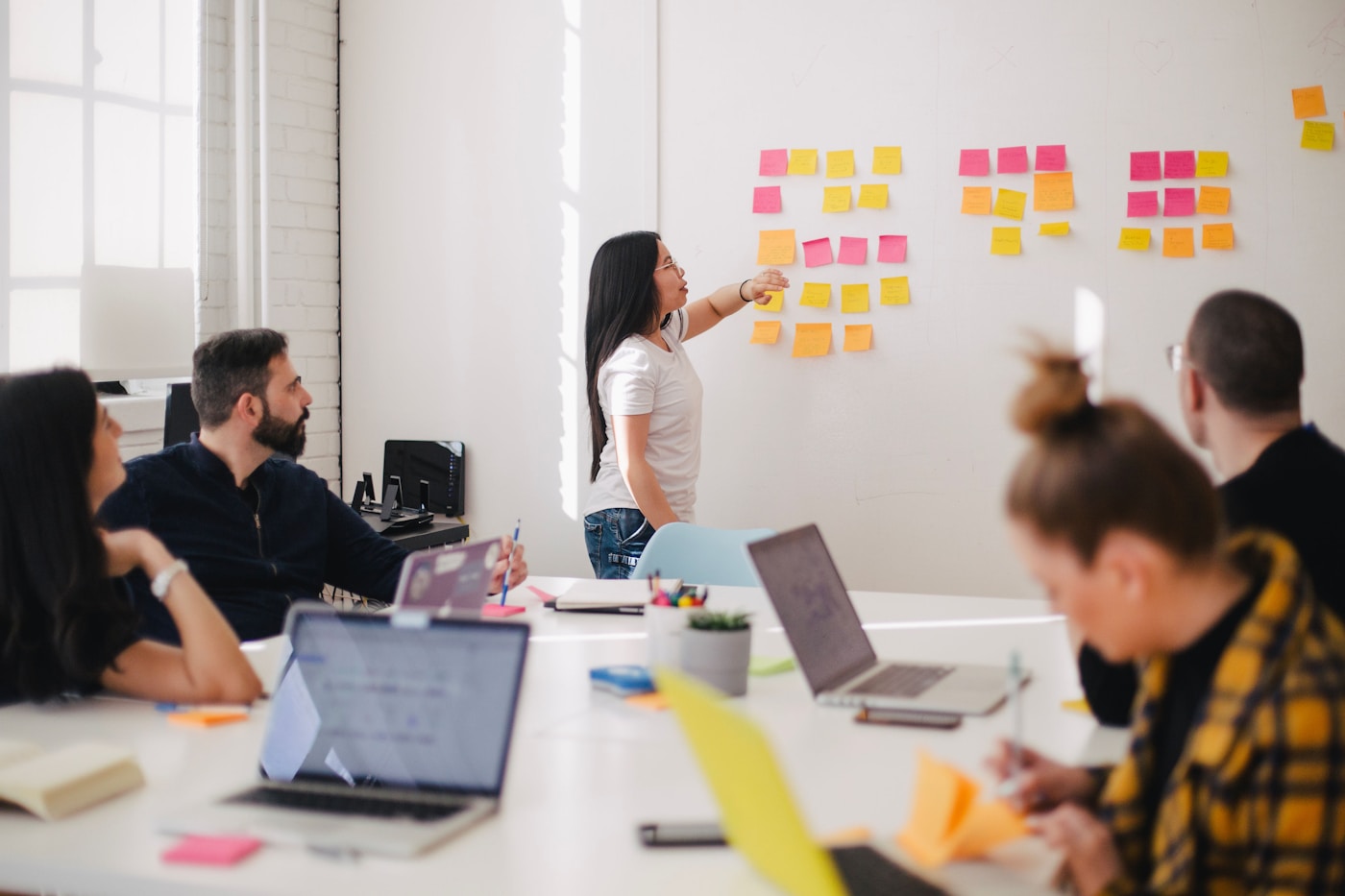 A whiteboard budget review during an AI finance operations programme